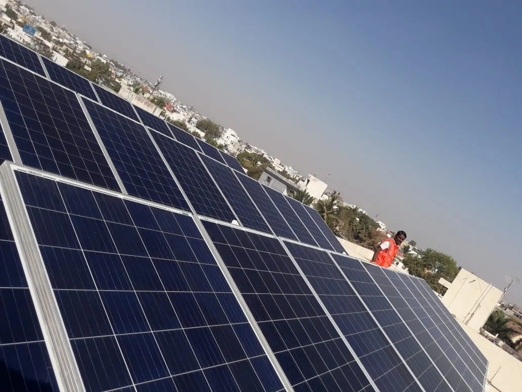 Waaree solar panels mounted on a commercial building rooftop in Maharashtra